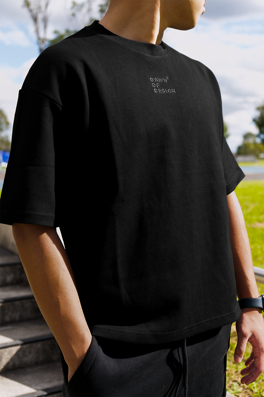 Model wearing a soft black t-shirt styled with casual basics