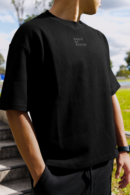 Model wearing a soft black t-shirt styled with casual basics