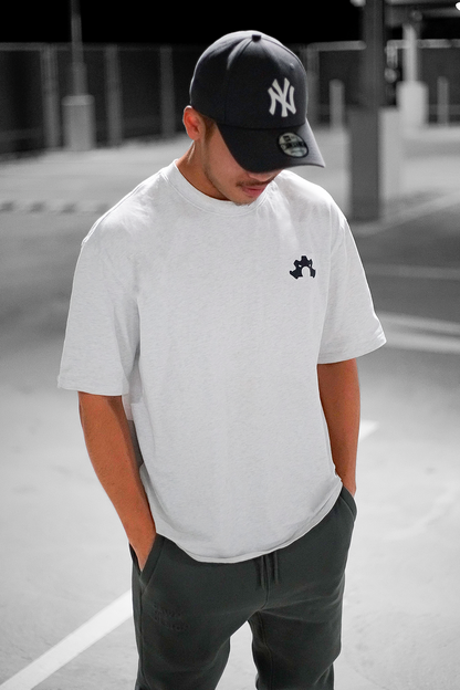 Essential white tee in a roomy, oversized fit styled casually for both men and women 