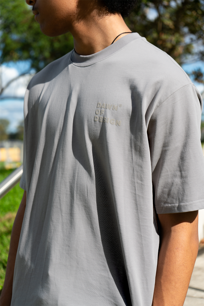 Model wearing a grey boxy-fit t-shirt with relaxed sleeves